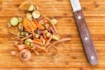 food scraps on cutting board with knife