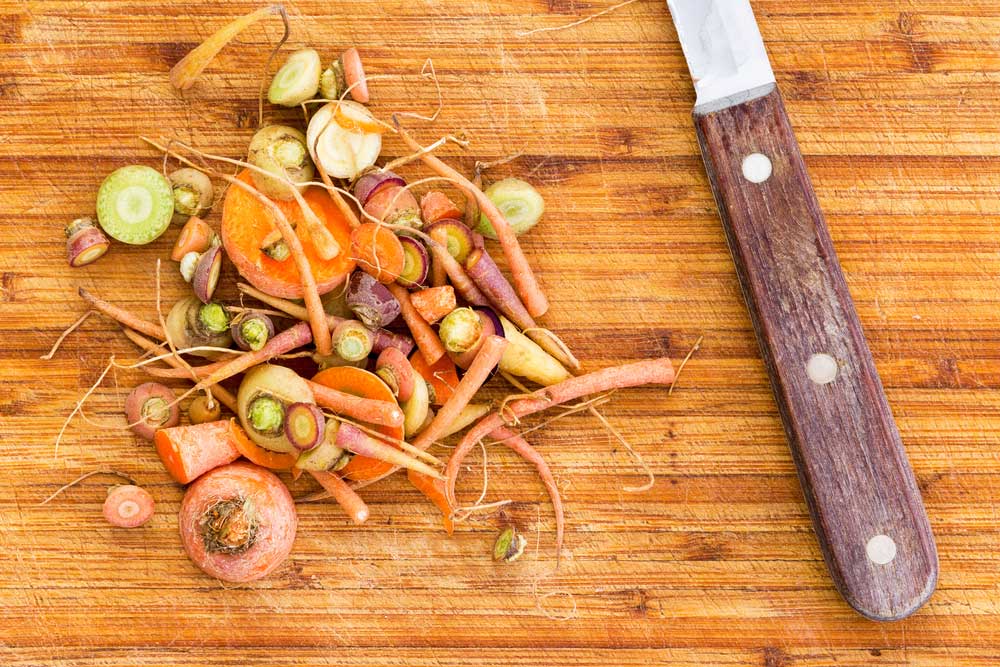 food scraps on cutting board with knife