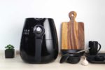Air Fryer on counter with bowls and cutting board