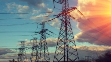 View of large power lines during a sunset
