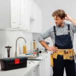 Plumber scratching his head