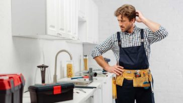 Plumber scratching his head