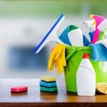 bucket of cleaning supplies on a counter top