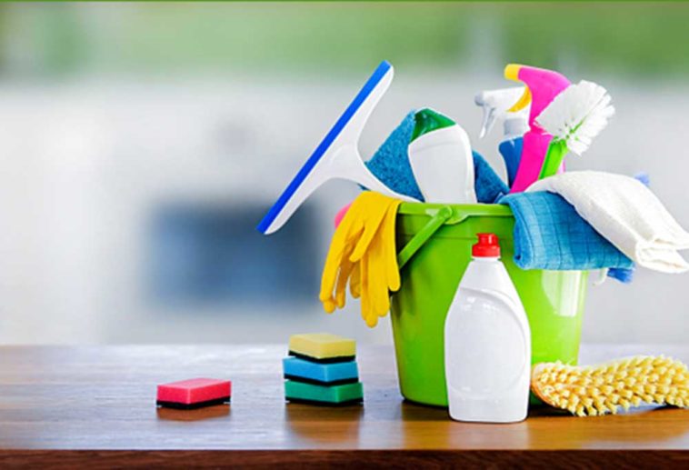 bucket of cleaning supplies on a counter top