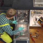 person installing dishwasher