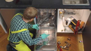 person installing dishwasher