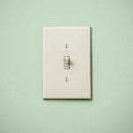 Light switch on green wall
