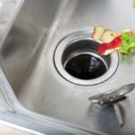 peels being put down the dink drain into the garbage disposal