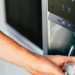 Person getting ice water from front of fridge