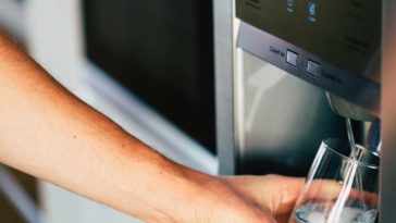 Person getting ice water from front of fridge