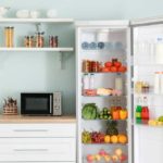 Teal kitchen with refrigerator with door open