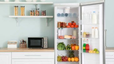 Teal kitchen with refrigerator with door open