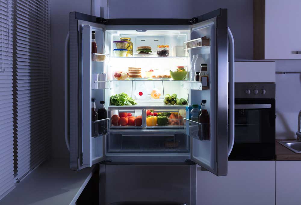 Dark kitchen with fridge doors open