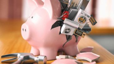 Busted piggy bank with tiny appliances spilling from the hole