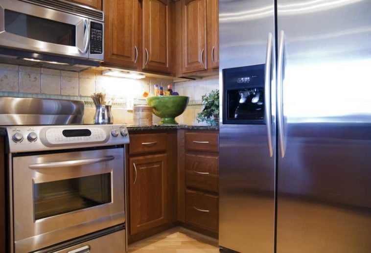 Stainless steel appliances in a kitchen with wood cabinets
