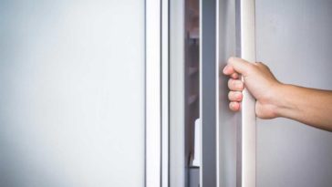 hand opening fridge door