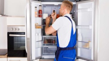 Man fixing refrigerator door