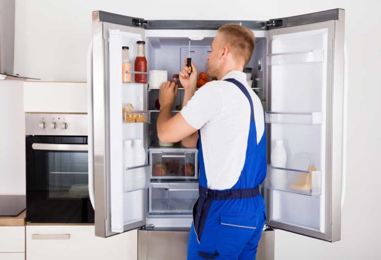 Man fixing refrigerator door