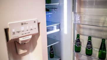 LG Refrigerator with door open and bottles in door