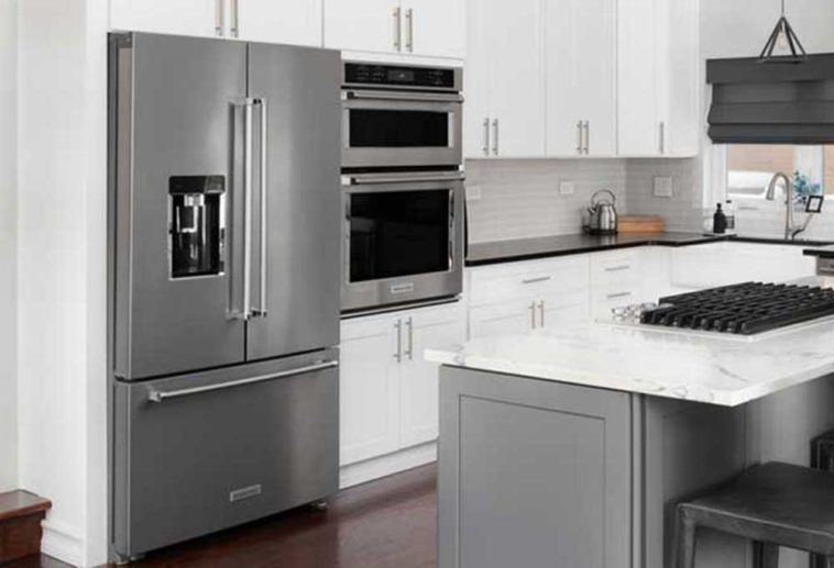 KitchenAid fridge with freezer on bottom in a white kitchen