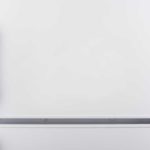 close up of a white fridge with a yellow door handle