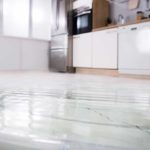Kitchen with water pooled on floor
