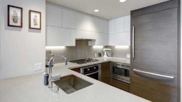 White kitchen with fridge covered in grey wood panel