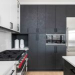 Kitchen with dark cabinets and stainless steel Sub-Zero refrigerator
