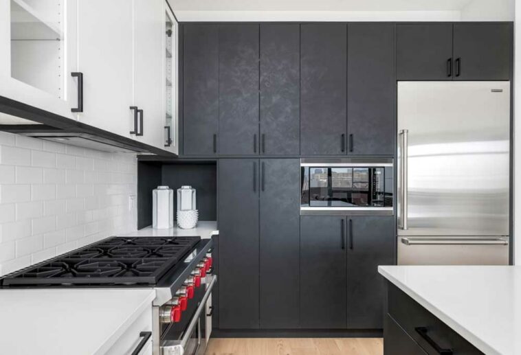 Kitchen with dark cabinets and stainless steel Sub-Zero refrigerator
