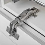 Cabinet door open with hinge exposed