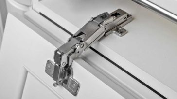 Cabinet door open with hinge exposed