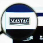 View of a magnifying glass with the logo for Maytag enlarged in the center
