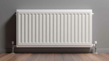 Gas wall heater on a grey wall with hard wood floors