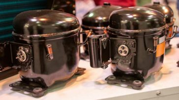 closeups of 3 black fridge compressors