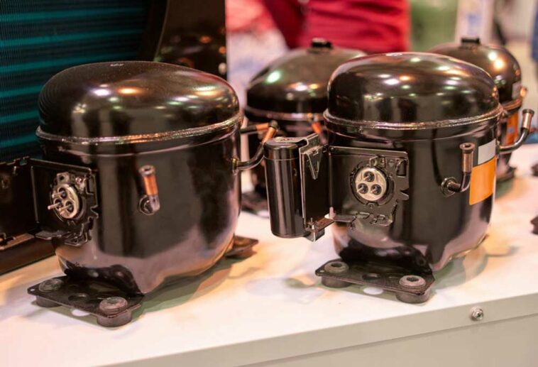 closeups of 3 black fridge compressors