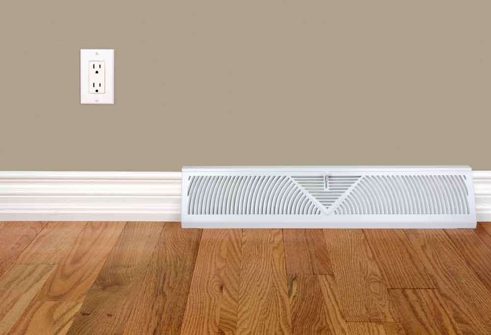 White floor board register vent for an air conditioner in a base board