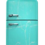 Teal colored fridge splattered with white on a white background