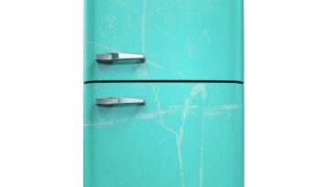 Teal colored fridge splattered with white on a white background