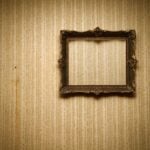 Old empty frame hanging on a wall in an old home.