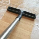 Wet vacuum suctioning water from hardwood floors