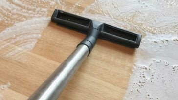 Wet vacuum suctioning water from hardwood floors