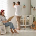 Parents decorating a babies room