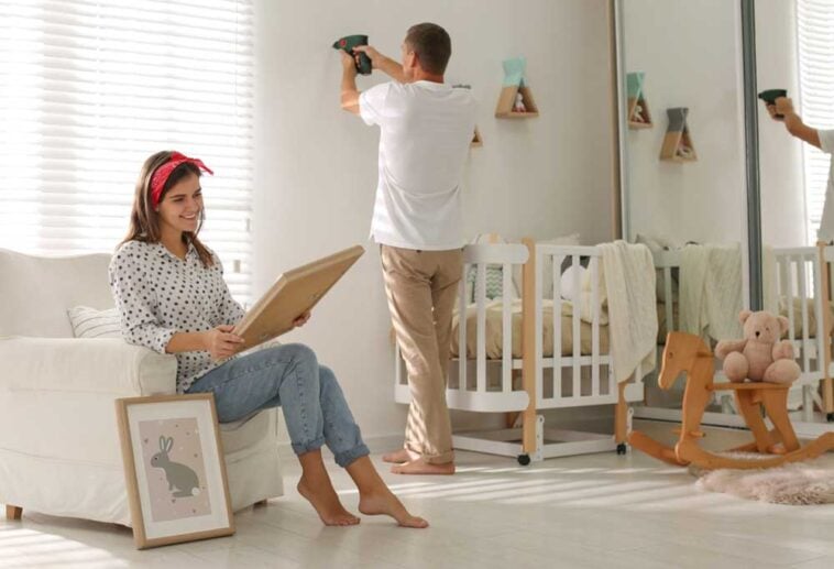Parents decorating a babies room