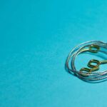 Picture wire and hooks on a blue background.