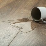 coffee cup of water spilled on hardwood floor