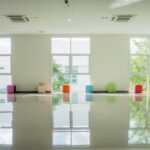 3 windows reflecting light onto a shiny white epoxy floor