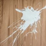 White paint spilled on hardwood dloors