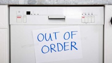 Dishwasher with an out of order sign on it