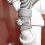 Dishwasher drain hose junction with the outgoing pipes from under the kitchen sink