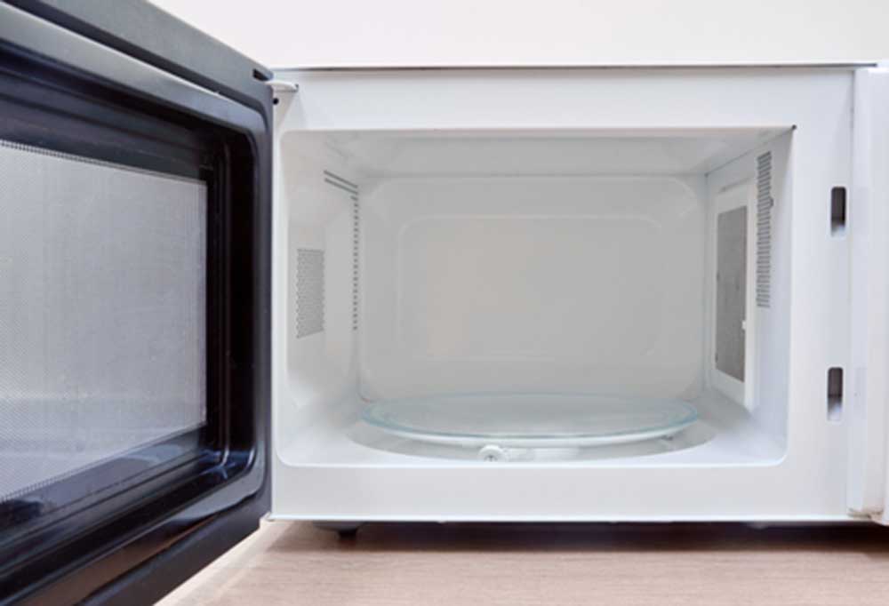 Close up of a open, clean microwave 